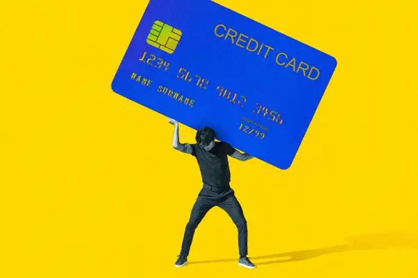 Photo Collage of a man carrying a giant credit card on his back