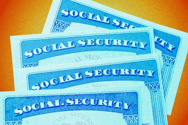 Photo Illustration of multiple Social Security Cards stacked on top of each other