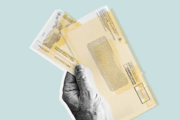 A hand holding overlapping Social Security Payments