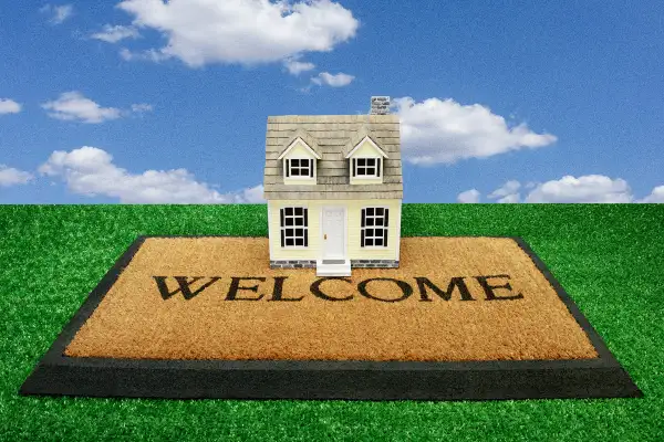 Photo collage of a home on top of a Welcome mat