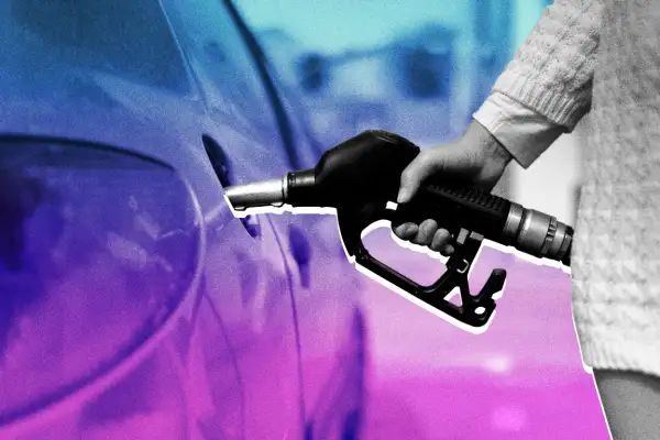 Close-up of a woman using a gas pump to fill a car