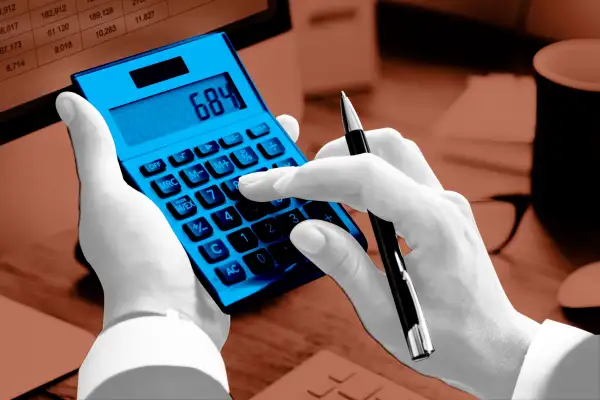 Close-up of a hand using a calculator