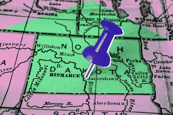 Map of North Dakota with the outline of a house and a push pin.