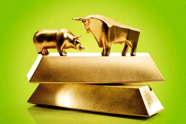 Bull and bear sculpture on top of gold bars