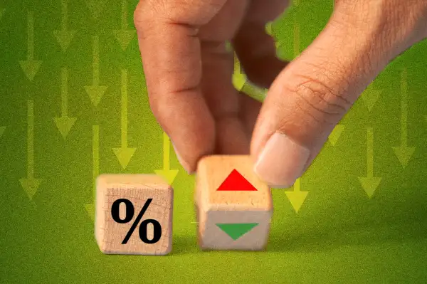 Close-up of a hand changing a wooden dice from an ascending to a descending arrow