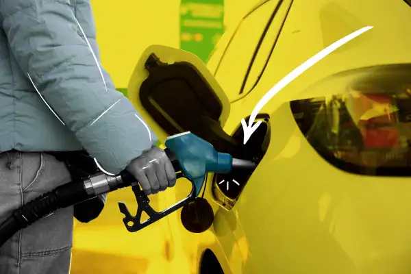 Close-up of a person filling their car with gasoline at a gas pump