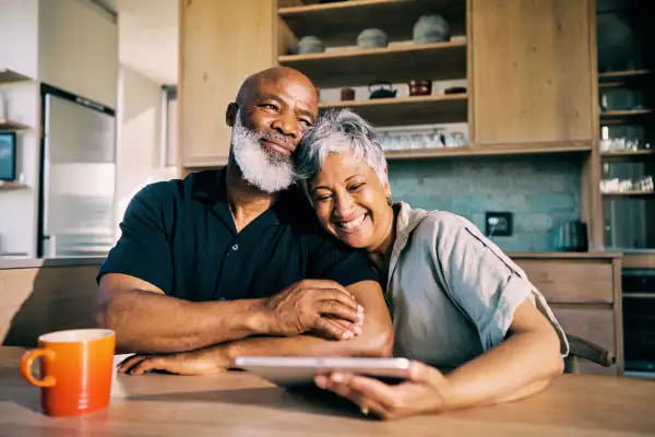 Senior couple embracing in their kitchen