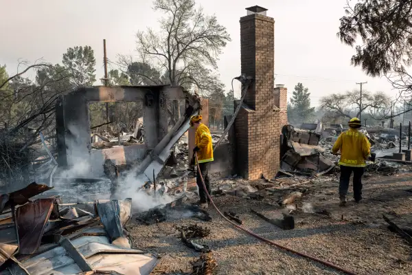 firefighters extinguish hotspots at a home destroyed by the Eaton Fire