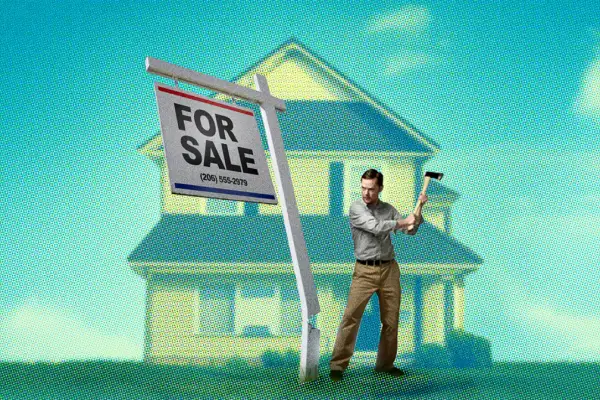 Man chopping down a  For Sale  sign in-front of a suburban house