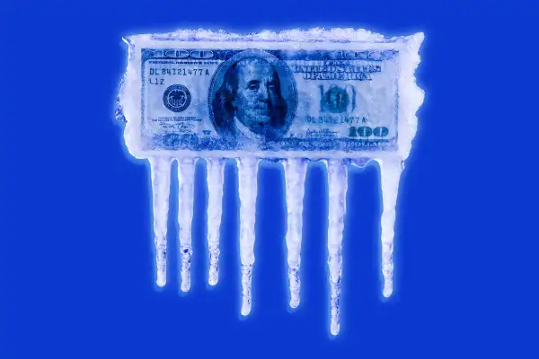 A hundred dollar bill in a block of melting ice