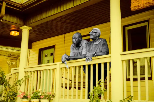 Senior couple standing outside on a home porch