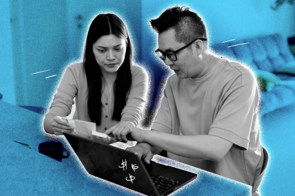 Couple looking over expenses while using a laptop