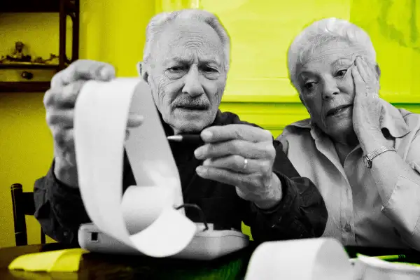 Senior couple looking over a very long receipt