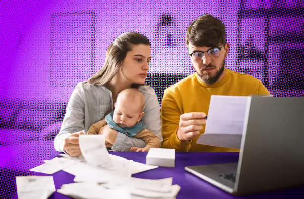 Couple with newborn baby looking over multiple receipts