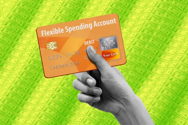 Close-up of a hand holding a FSA debit card, with money in the background