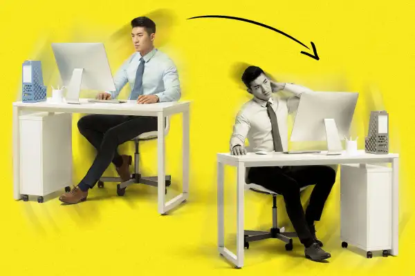 Mirror image of a man working at a desk, in opposite positions