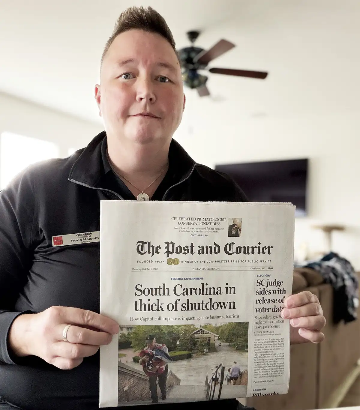 Halseth poses with a newspaper on Oct. 2, 2025, in hopes of convincing the credit bureaus that she is alive after they marked her credit file as deceased. Photo of a person who is holding The Post And Courier newspaper.